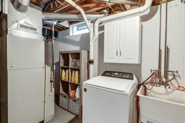 clothes washing area with sink and washer / dryer