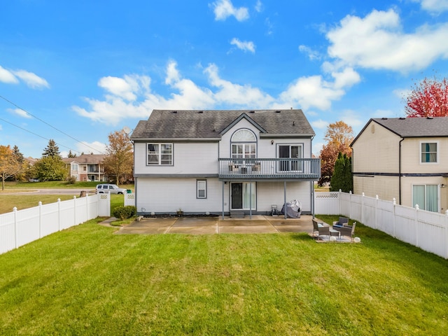 rear view of property featuring a lawn and a patio area