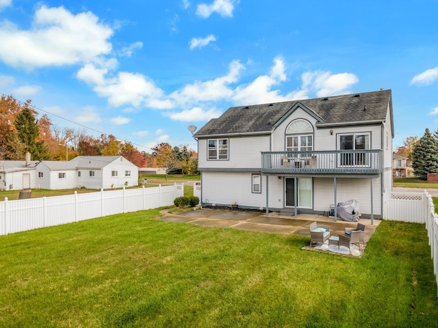 back of property with outdoor lounge area, a patio area, and a yard