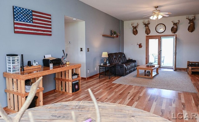 living room featuring ceiling fan, wood-type flooring, and french doors