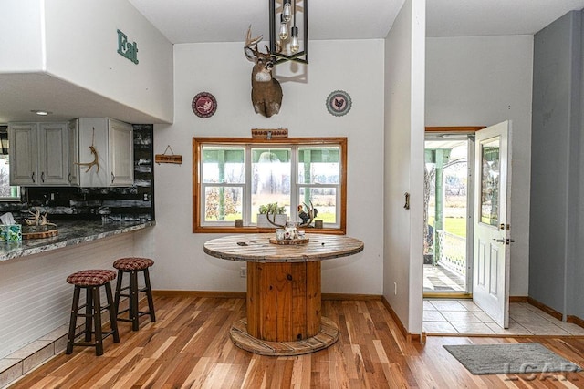 kitchen featuring a healthy amount of sunlight, light hardwood / wood-style floors, and kitchen peninsula