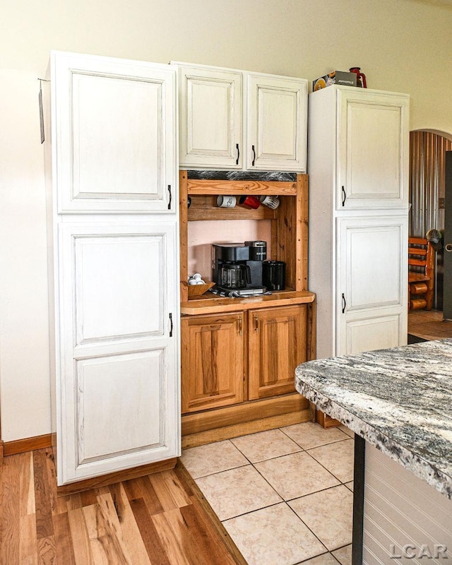 kitchen featuring light hardwood / wood-style flooring and stone countertops