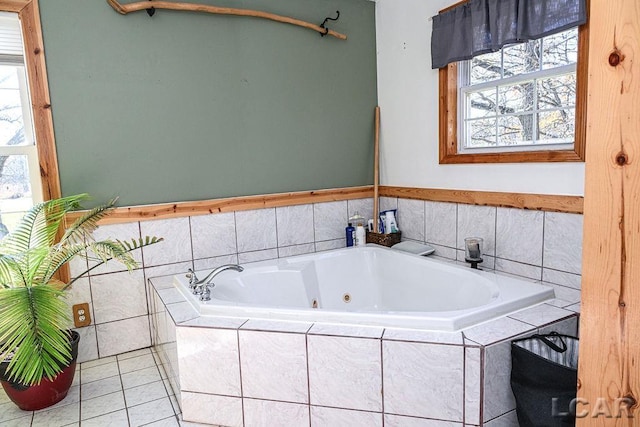 bathroom with tile patterned floors and tiled bath