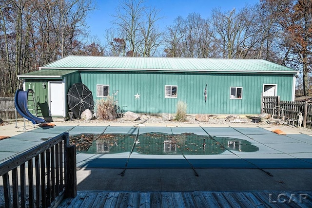 view of outdoor structure featuring a covered pool