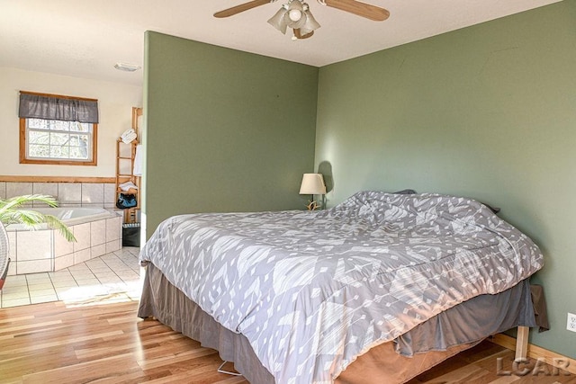 bedroom featuring light hardwood / wood-style floors and ceiling fan