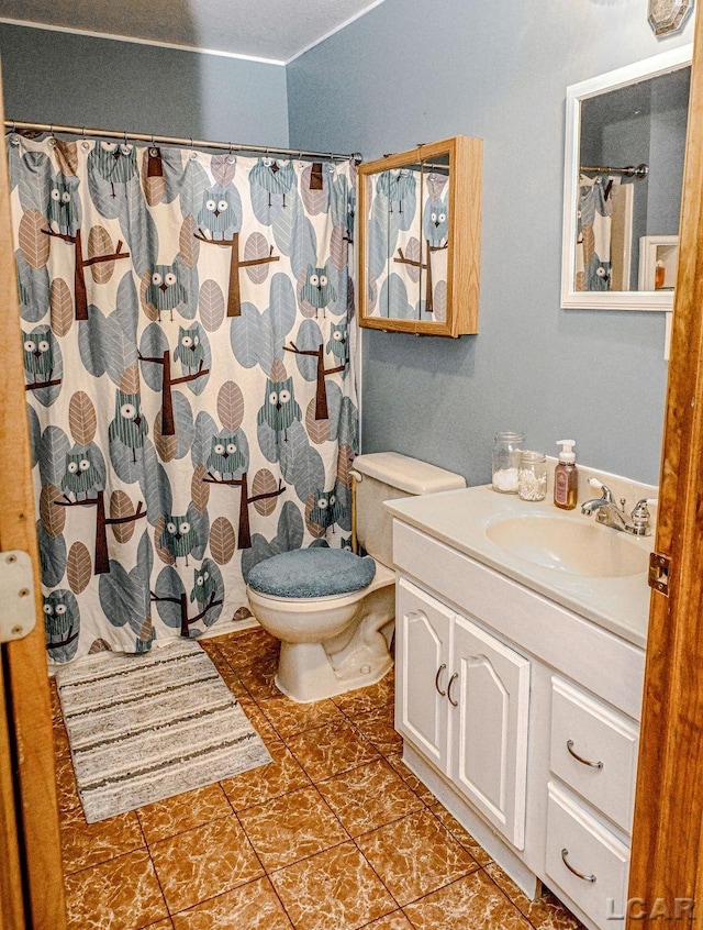 bathroom with tile patterned floors, vanity, and toilet