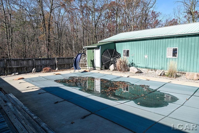 view of pool featuring a patio area and a water slide