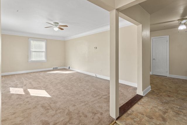 empty room with carpet flooring, ceiling fan, and ornamental molding