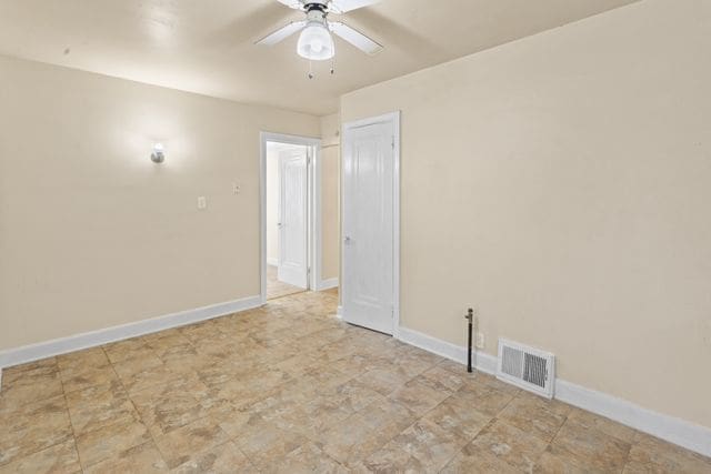 unfurnished room with ceiling fan