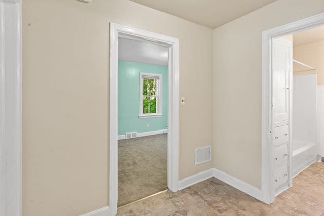 hallway with light carpet