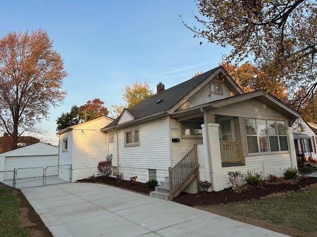 bungalow with an outbuilding and a garage