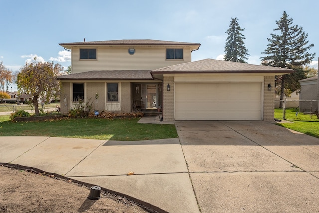 view of front of property featuring a garage and a front lawn