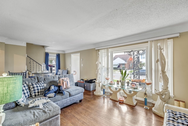 living room with hardwood / wood-style floors and a textured ceiling