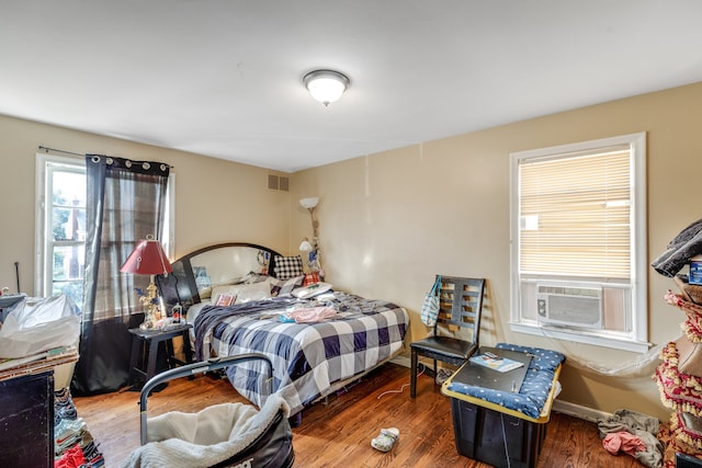 bedroom featuring hardwood / wood-style flooring and cooling unit