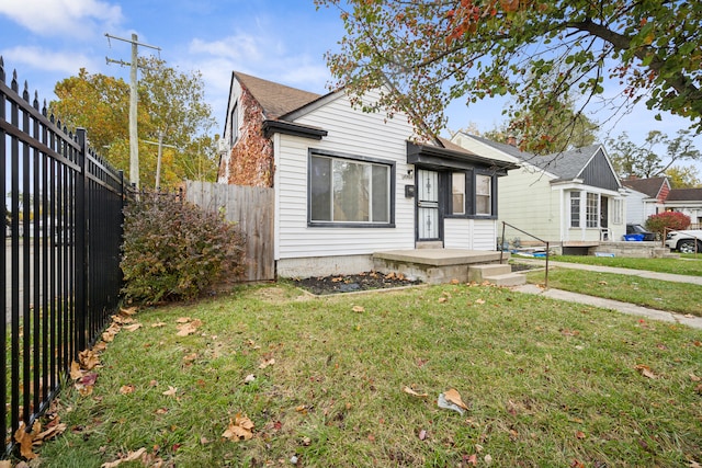 bungalow-style home with a front lawn