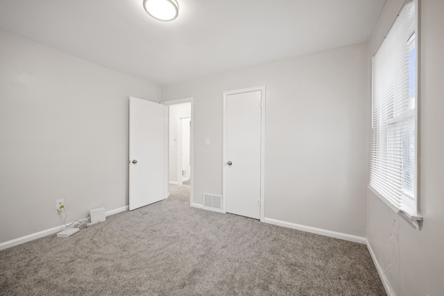 unfurnished bedroom with carpet flooring and a closet