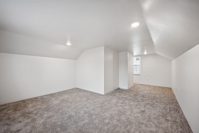 bonus room featuring carpet floors and lofted ceiling