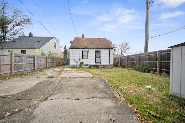 back of house featuring a yard and a patio