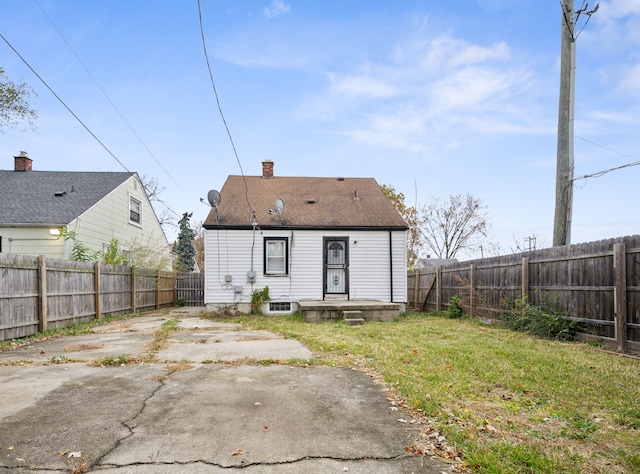 rear view of house featuring a patio and a lawn