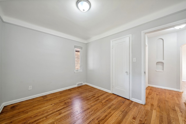 unfurnished bedroom with a closet and light hardwood / wood-style floors