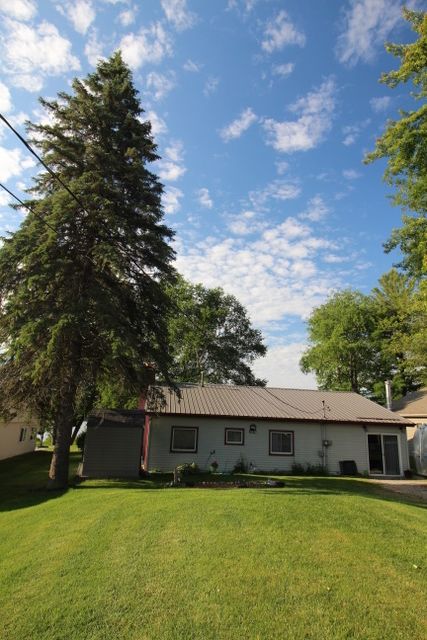 rear view of property with a yard