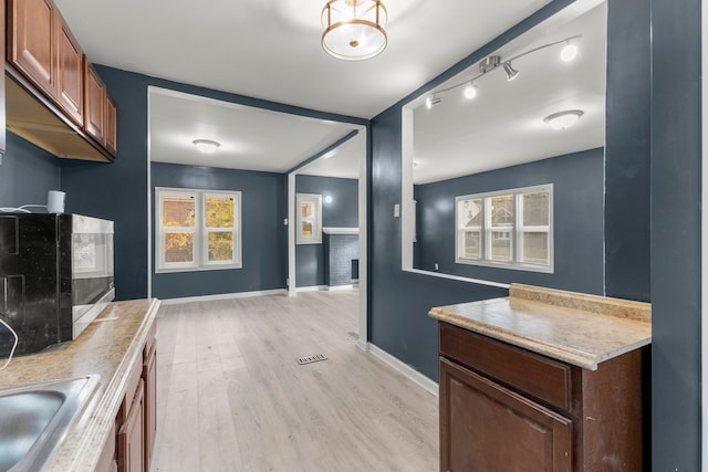 kitchen with sink and light hardwood / wood-style floors