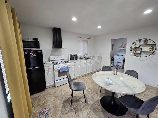 kitchen featuring exhaust hood, white cabinets, black fridge, sink, and gas range gas stove