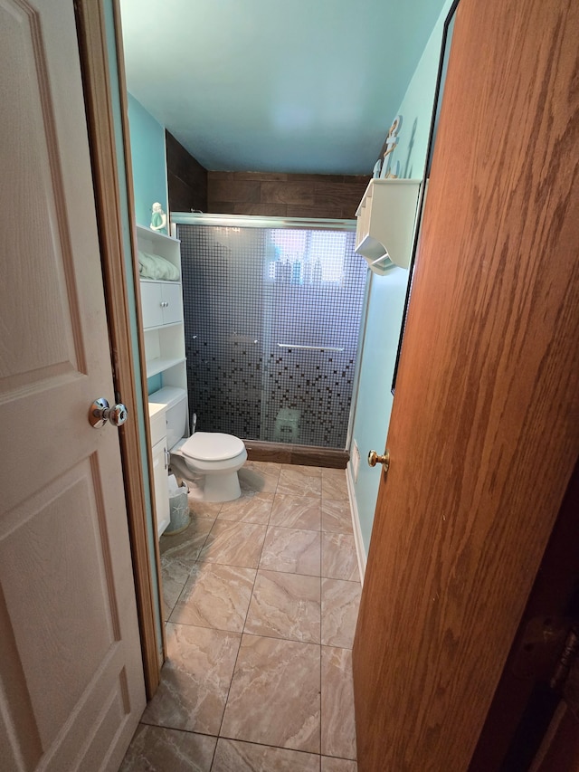 bathroom featuring an enclosed shower, toilet, and tile patterned floors