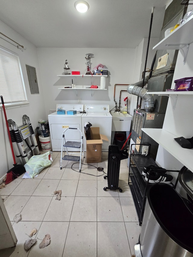 interior space featuring light tile patterned floors, independent washer and dryer, sink, and electric panel