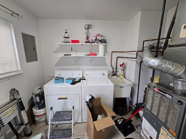 washroom with sink, washing machine and dryer, electric panel, heating unit, and light tile patterned floors