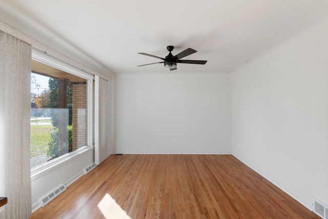 empty room with ceiling fan and light wood-type flooring