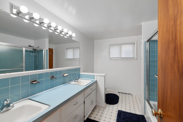 bathroom with vanity and enclosed tub / shower combo