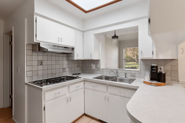 kitchen with white cabinets, sink, and stainless steel gas cooktop