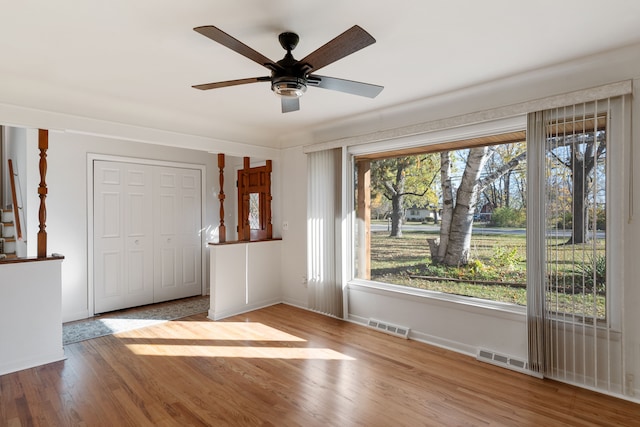 unfurnished room with ceiling fan and light wood-type flooring