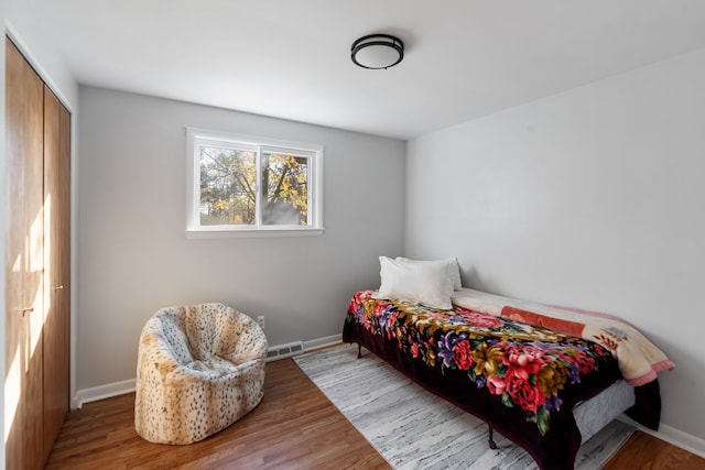 bedroom featuring a closet and light hardwood / wood-style flooring