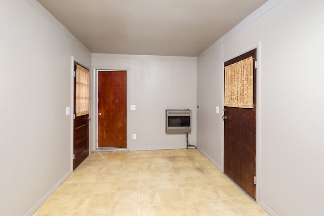 laundry room with heating unit and crown molding