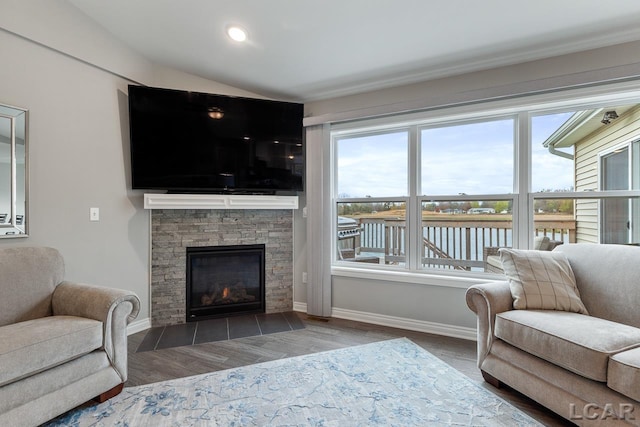 living room with dark hardwood / wood-style flooring and a fireplace