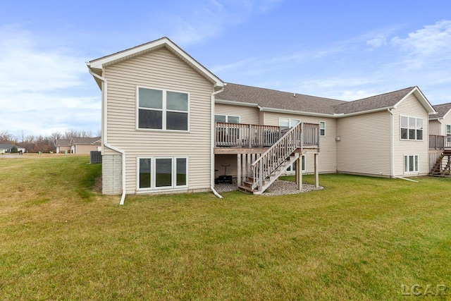 rear view of property featuring a lawn and a wooden deck