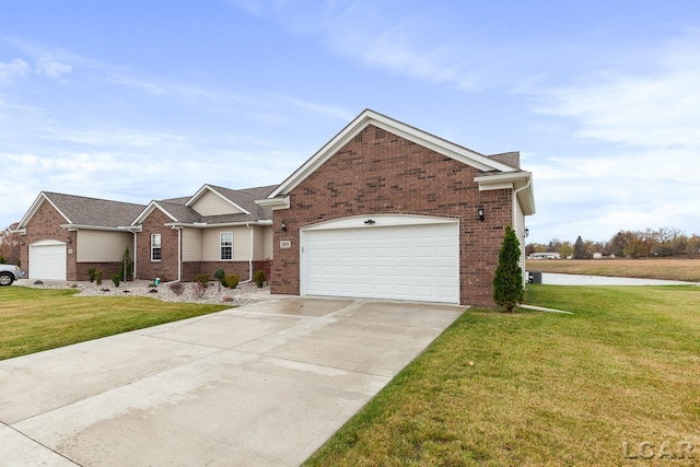 view of front of house with a front yard and a garage