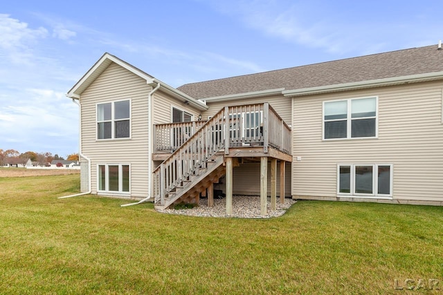 rear view of property with a yard and a deck