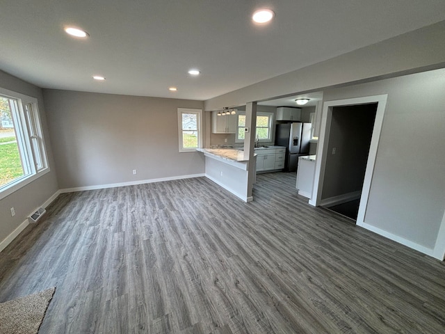 unfurnished living room with dark hardwood / wood-style floors and sink