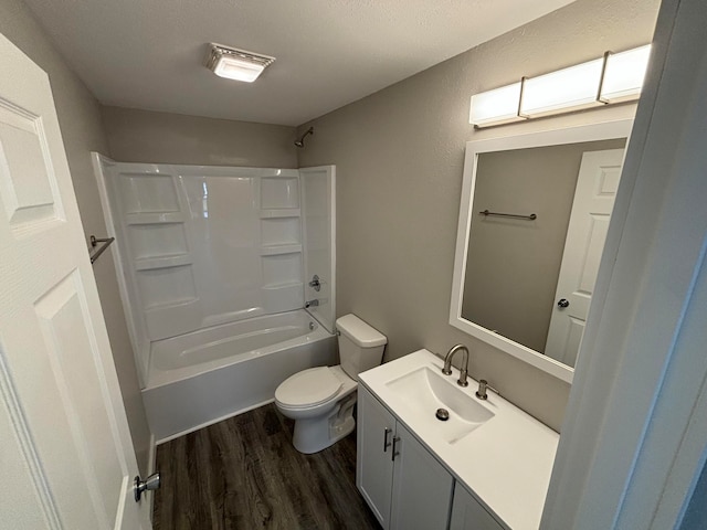 full bathroom with shower / tub combination, vanity, hardwood / wood-style flooring, and toilet