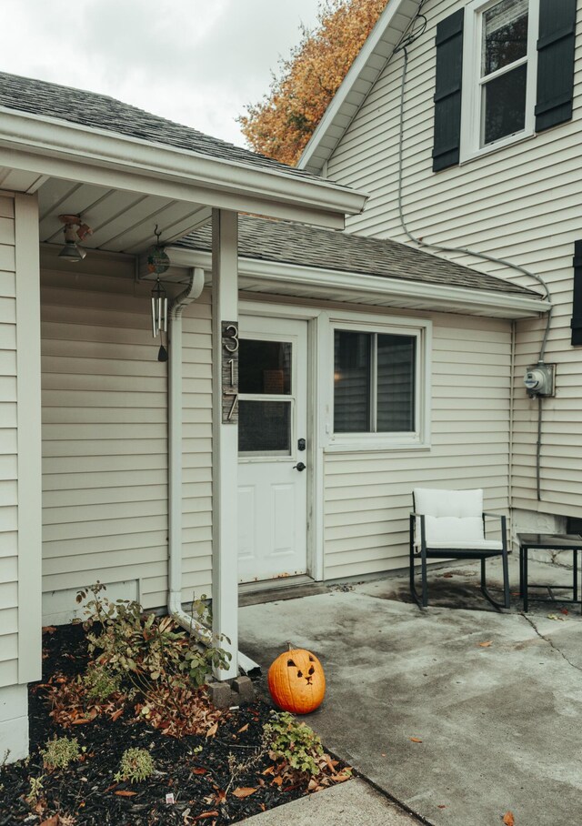 317 Maiden Ln, Saint Joseph, MI 49085 - property entrance with roof with shingles and a patio area