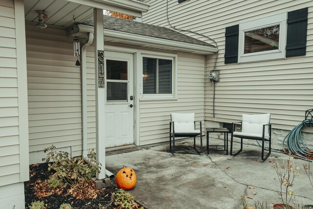 317 Maiden Ln, Saint Joseph, MI 49085 - view of exterior entry with a patio area and a shingled roof