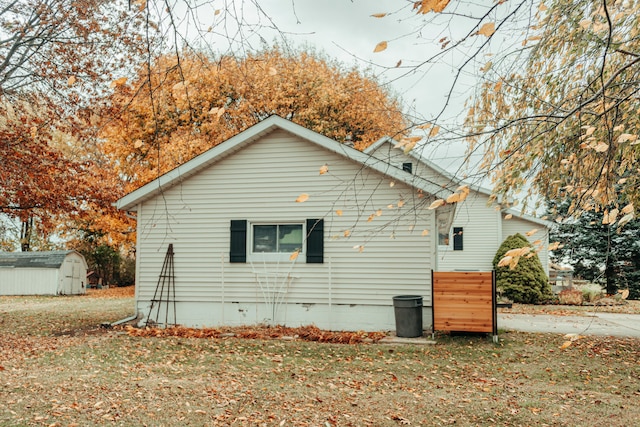 view of side of property featuring a shed