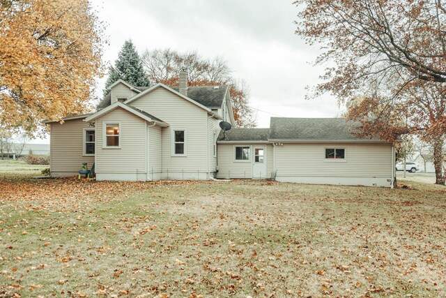 317 Maiden Ln, Saint Joseph, MI 49085 - back of property with a yard, a chimney, and roof with shingles