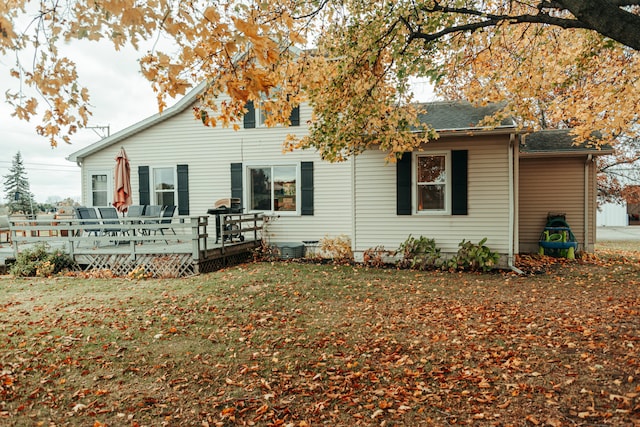 rear view of property featuring a deck