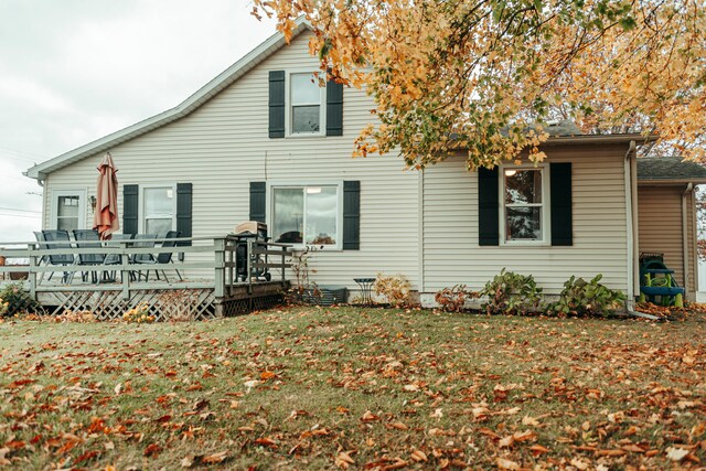 back of house featuring a yard and a wooden deck