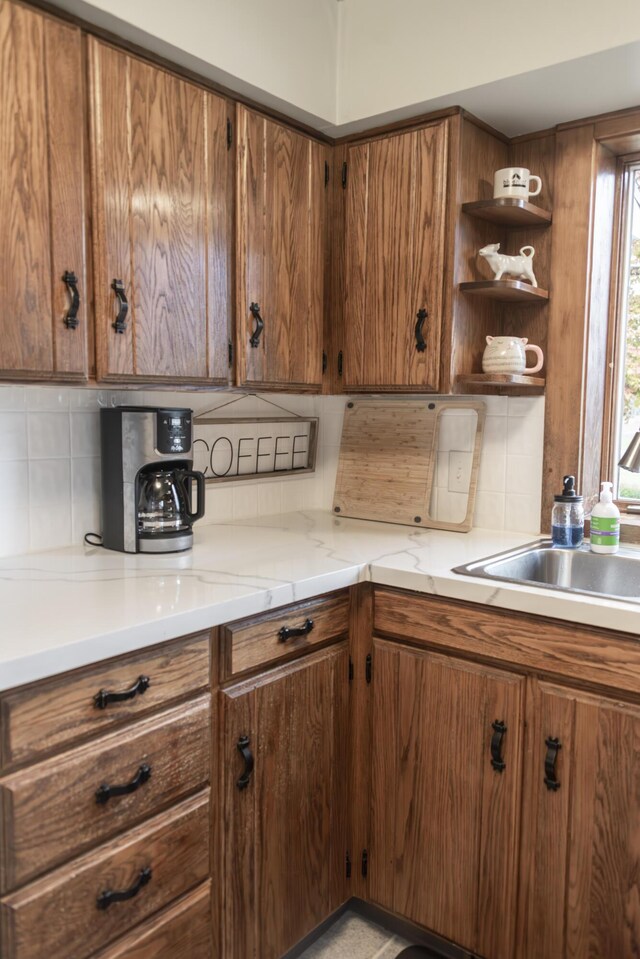 317 Maiden Ln, Saint Joseph, MI 49085 - kitchen featuring brown cabinets, decorative backsplash, a sink, and open shelves