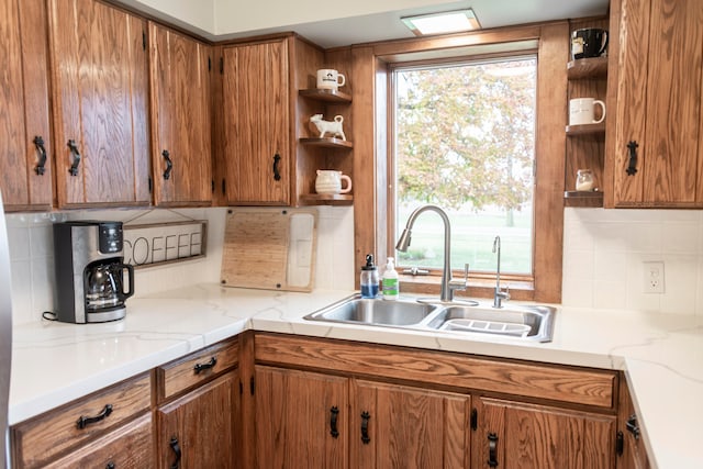 kitchen featuring plenty of natural light, sink, and tasteful backsplash